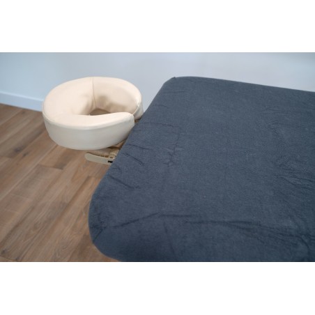 Housse de table de massage en tissu doux, couleur anthracite, pour un confort amélioré.